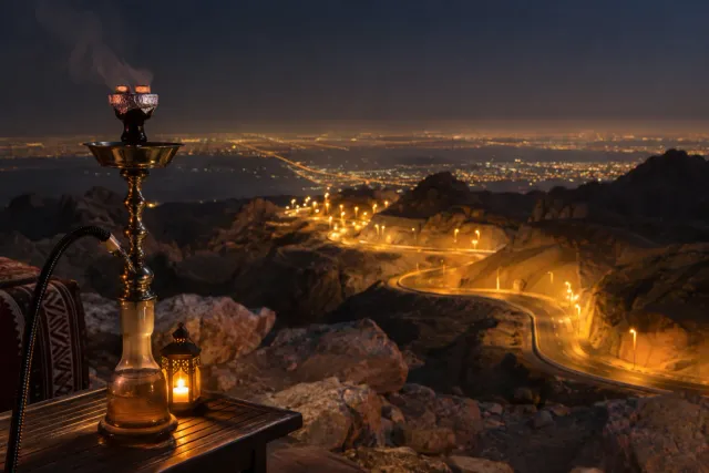 Jebel Hafeet base shisha — mountain road lights at night